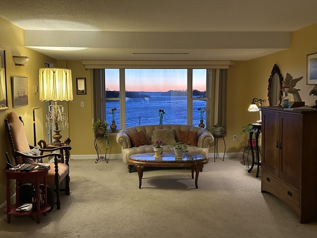 9 Park Avenue, Unit 705 Hull, MA 02045 - Photo 2 of 22 a living room with furniture and wooden floor