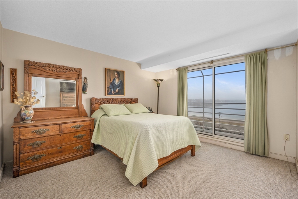 9 Park Avenue, Unit 705 Hull, MA 02045 - Photo 8 of 22 a spacious bedroom with a bed and a dresser