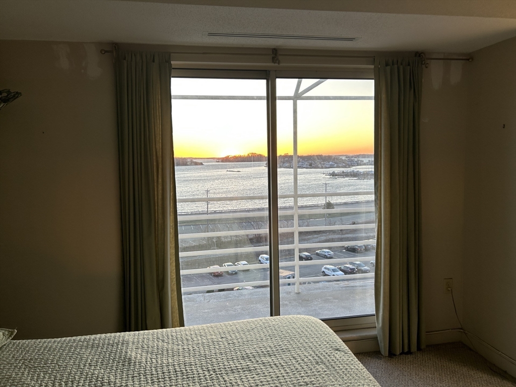 9 Park Avenue, Unit 705 Hull, MA 02045 - Photo 9 of 22 a bedroom with a bed and a large window