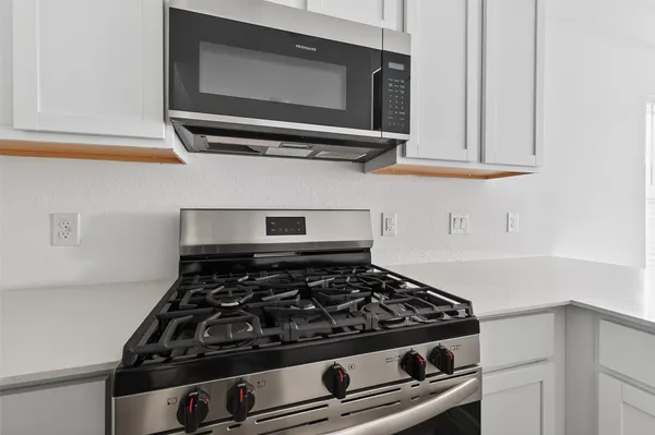 a stove top oven sitting inside of a kitchen