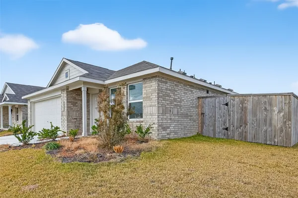 a view of a house with wooden fence