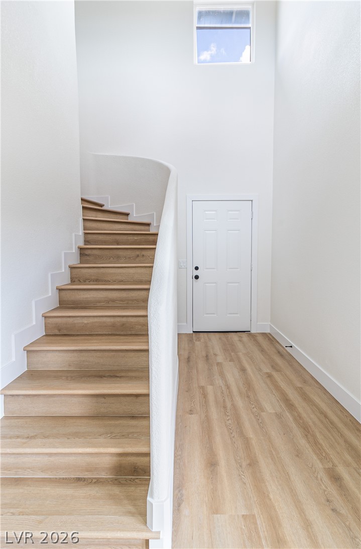 1891 Brian Road Pahrump, NV 89048 - Photo 24 of 50 Staircase featuring baseboards and wood finished floors