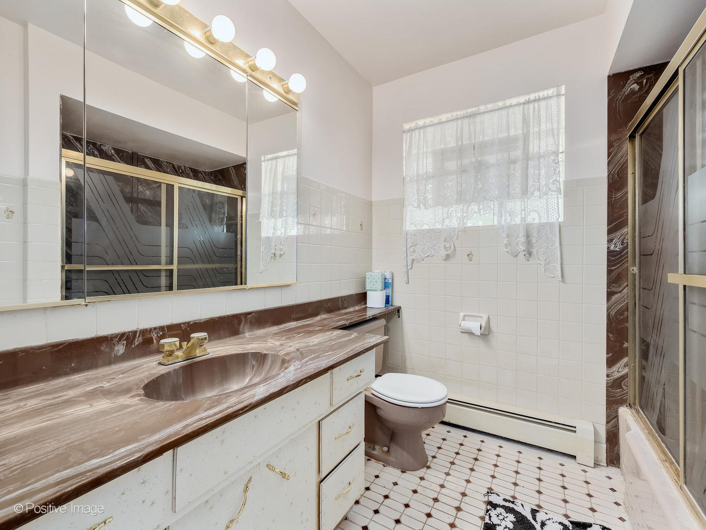 365 Olmsted Road Riverside, IL 60546 - Photo 12 of 23 a bathroom with a sink a toilet a mirror and shower