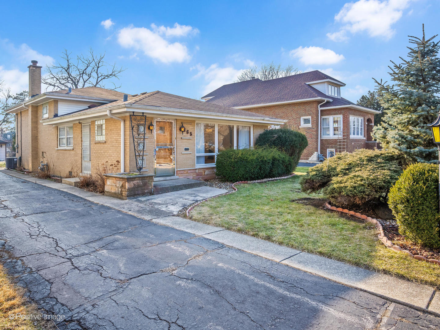 365 Olmsted Road Riverside, IL 60546 - Photo 2 of 23 a front view of a house with a yard and potted plants