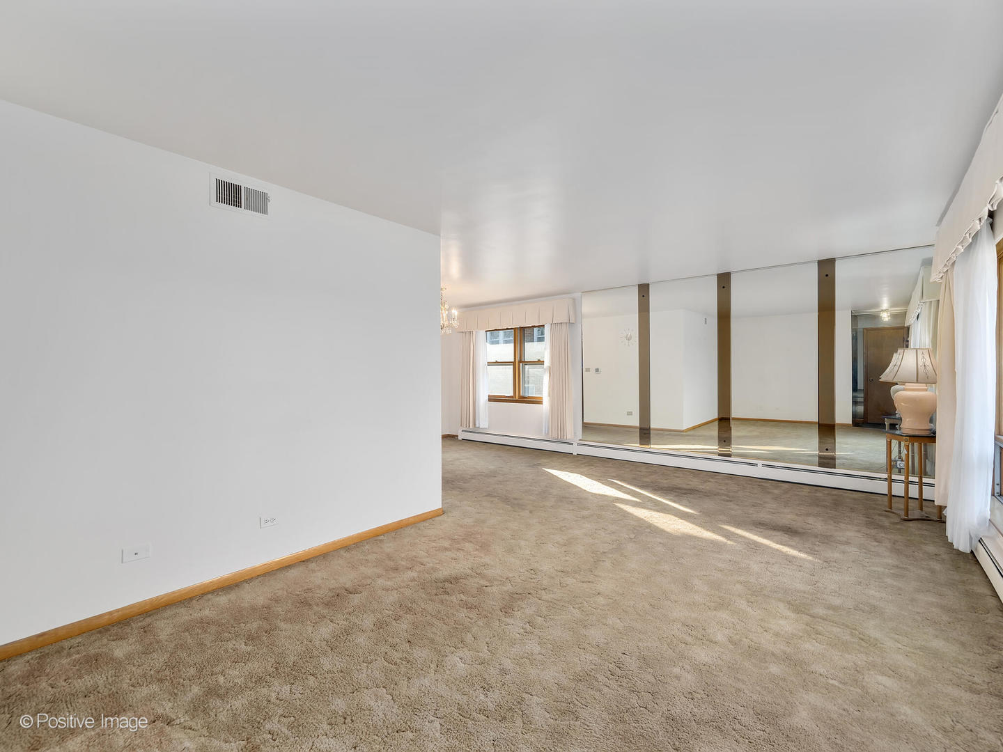 365 Olmsted Road Riverside, IL 60546 - Photo 4 of 23 an empty room with a window and a bathroom