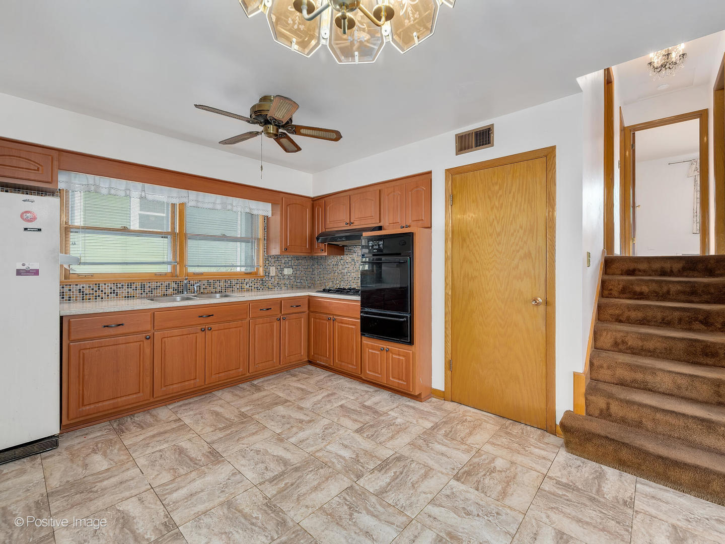 365 Olmsted Road Riverside, IL 60546 - Photo 8 of 23 a kitchen with granite countertop a refrigerator and cabinets