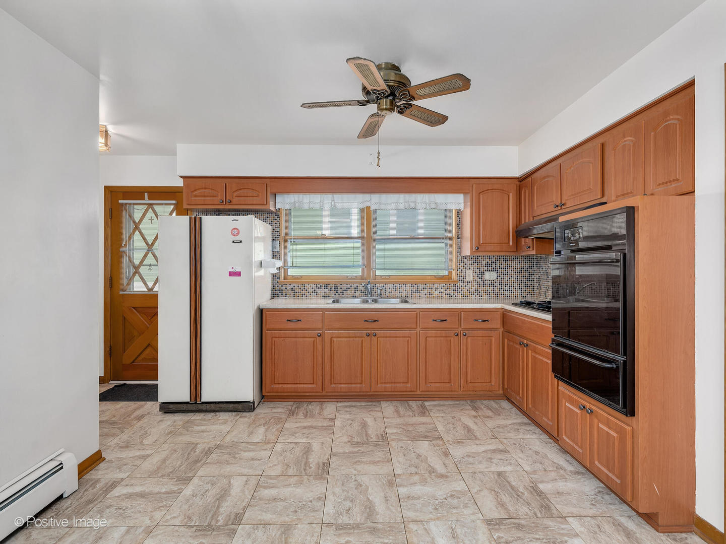 365 Olmsted Road Riverside, IL 60546 - Photo 9 of 23 a kitchen with a refrigerator and microwave