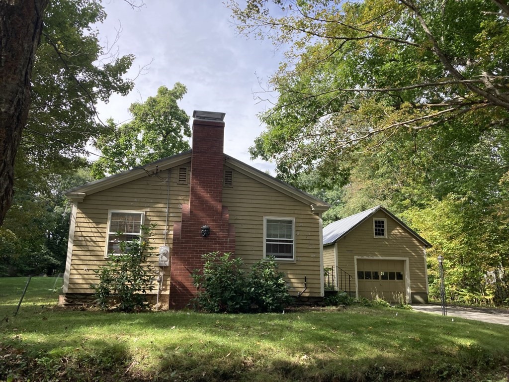 151 Ridge Road Rutland, MA 01543 - Photo 1 of 8 a front view of a house with a garden