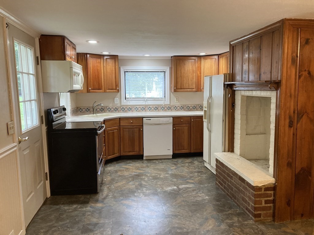 151 Ridge Road Rutland, MA 01543 - Photo 3 of 8 a kitchen with kitchen island granite countertop a sink stove and refrigerator