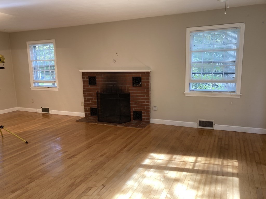 151 Ridge Road Rutland, MA 01543 - Photo 4 of 8 a view of empty room with wooden floor and fireplace