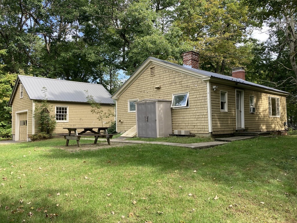 151 Ridge Road Rutland, MA 01543 - Photo 7 of 8 a backyard of a house with table and chairs