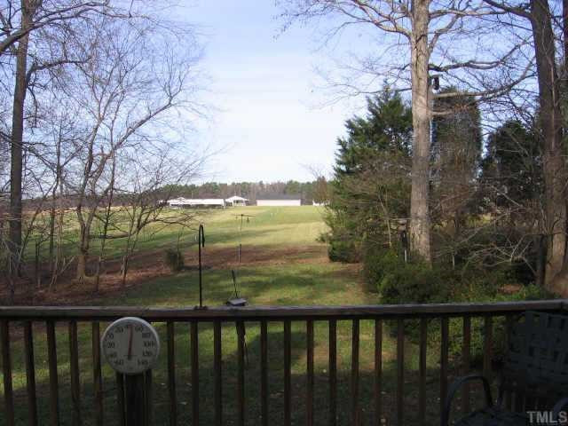 6202 Arrington Road Raleigh, NC 27607 - Photo 2 of 10 View from deck overlooking landscaped backyard. NCSU property backs up to the lot. Almost like country living! Other