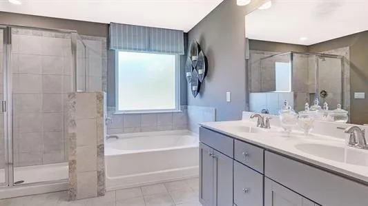 a bathroom with a bathtub shower sink vanity and mirror
