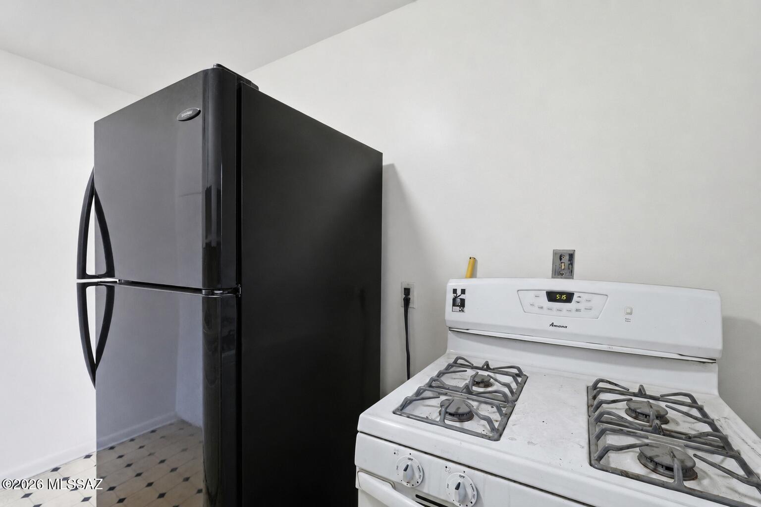 2721 East Fort Lowell Road Tucson, AZ 85716 - Photo 12 of 28 a kitchen with a refrigerator and a stove top oven