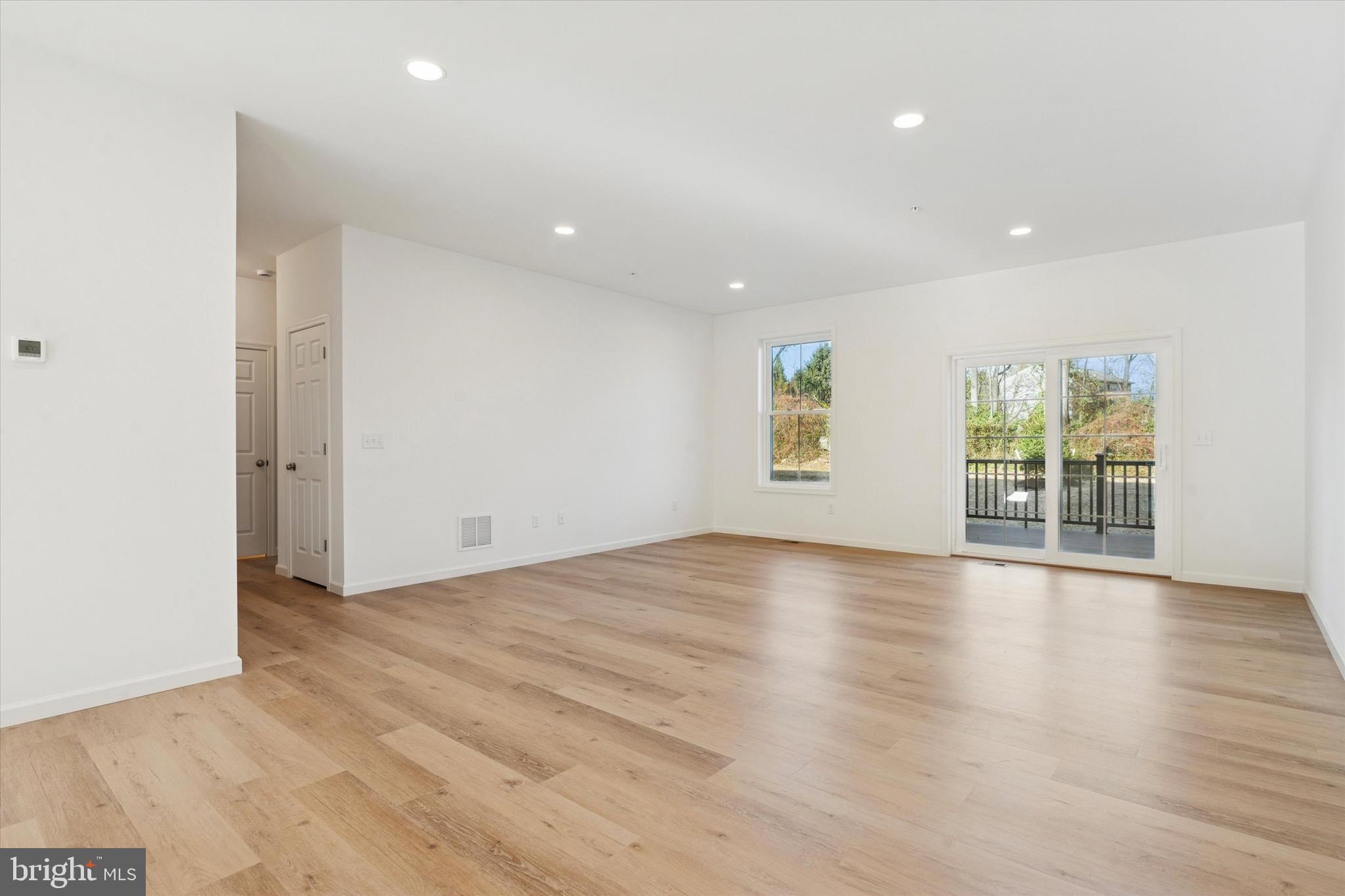 144 Silversmith Road Oxford, PA 19363 - Photo 12 of 20 an empty room with wooden floor and windows