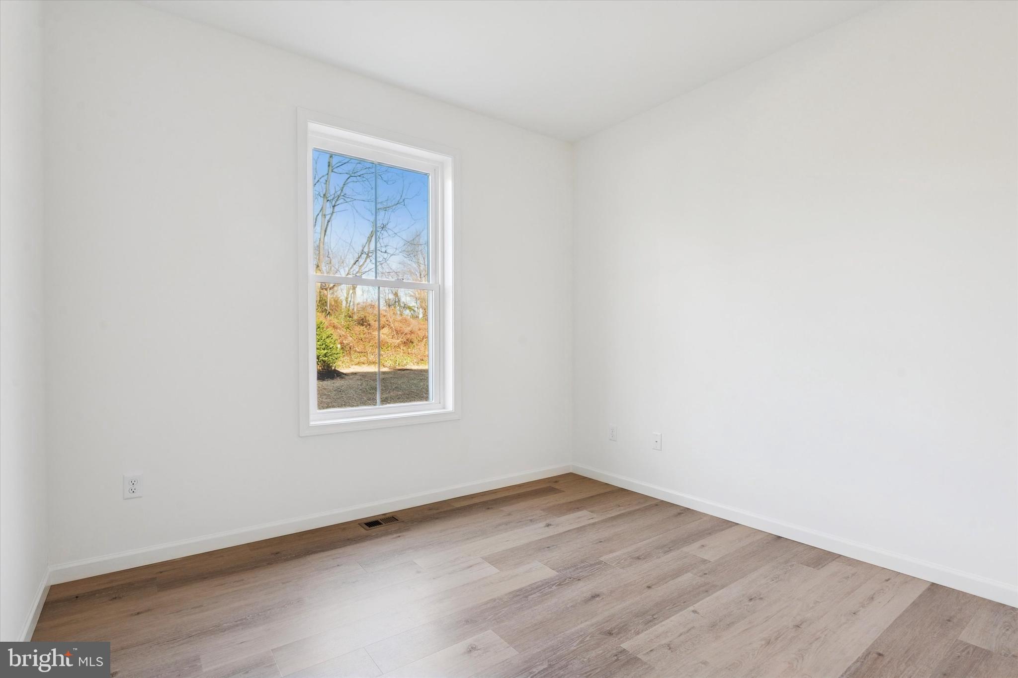 144 Silversmith Road Oxford, PA 19363 - Photo 16 of 20 an empty room with wooden floor and windows