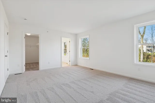 a bathroom with a double vanity sink mirror and toilet