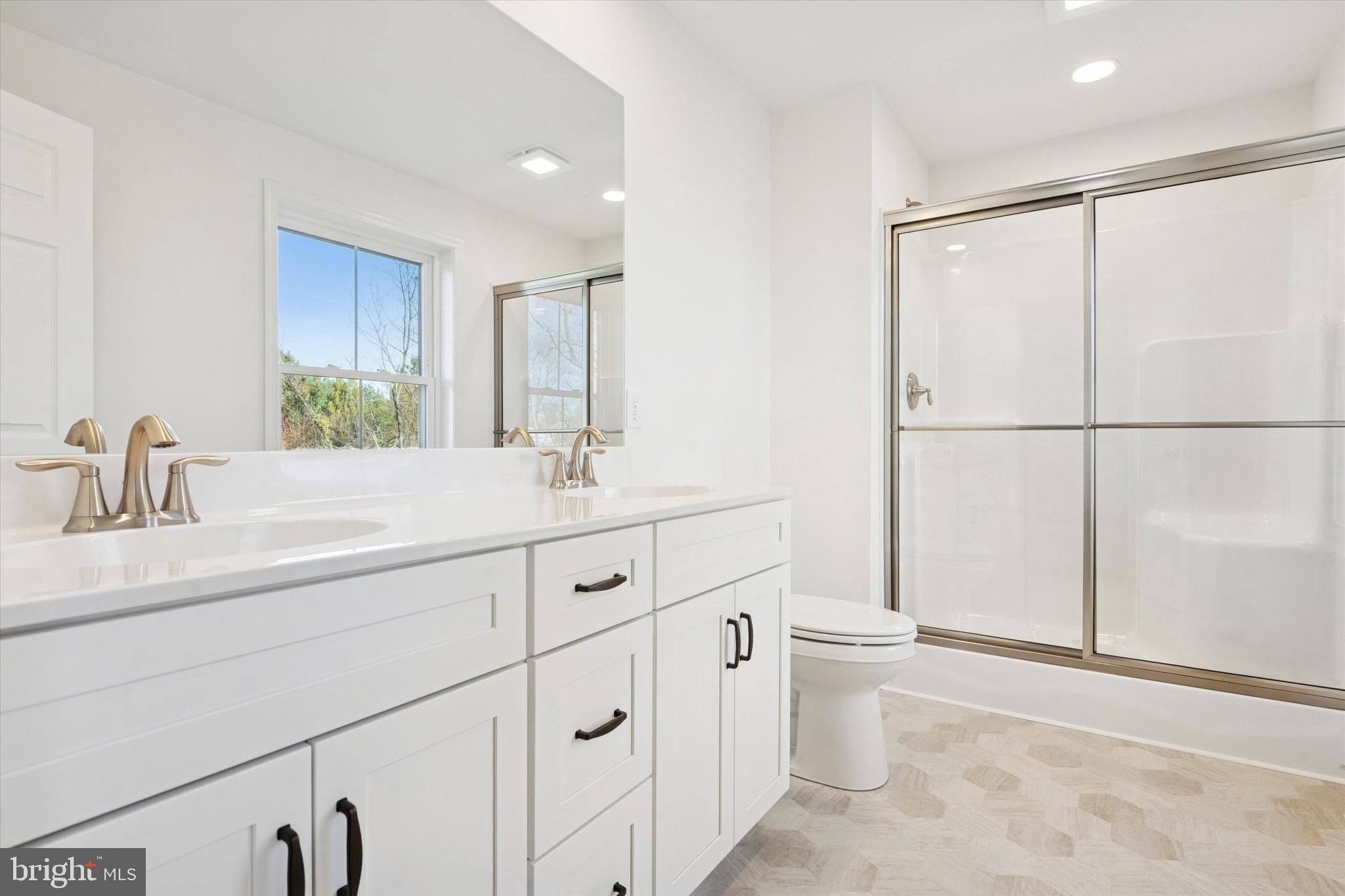 144 Silversmith Road Oxford, PA 19363 - Photo 7 of 20 a bathroom with a double vanity sink mirror and toilet