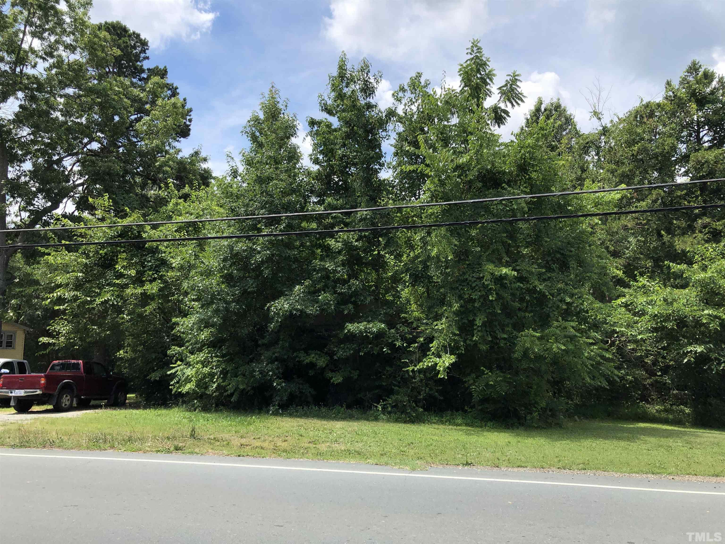 277 Cavel Chub Lake Road Roxboro, NC 27574 - Photo 22 of 24 a view of a field of grass and trees