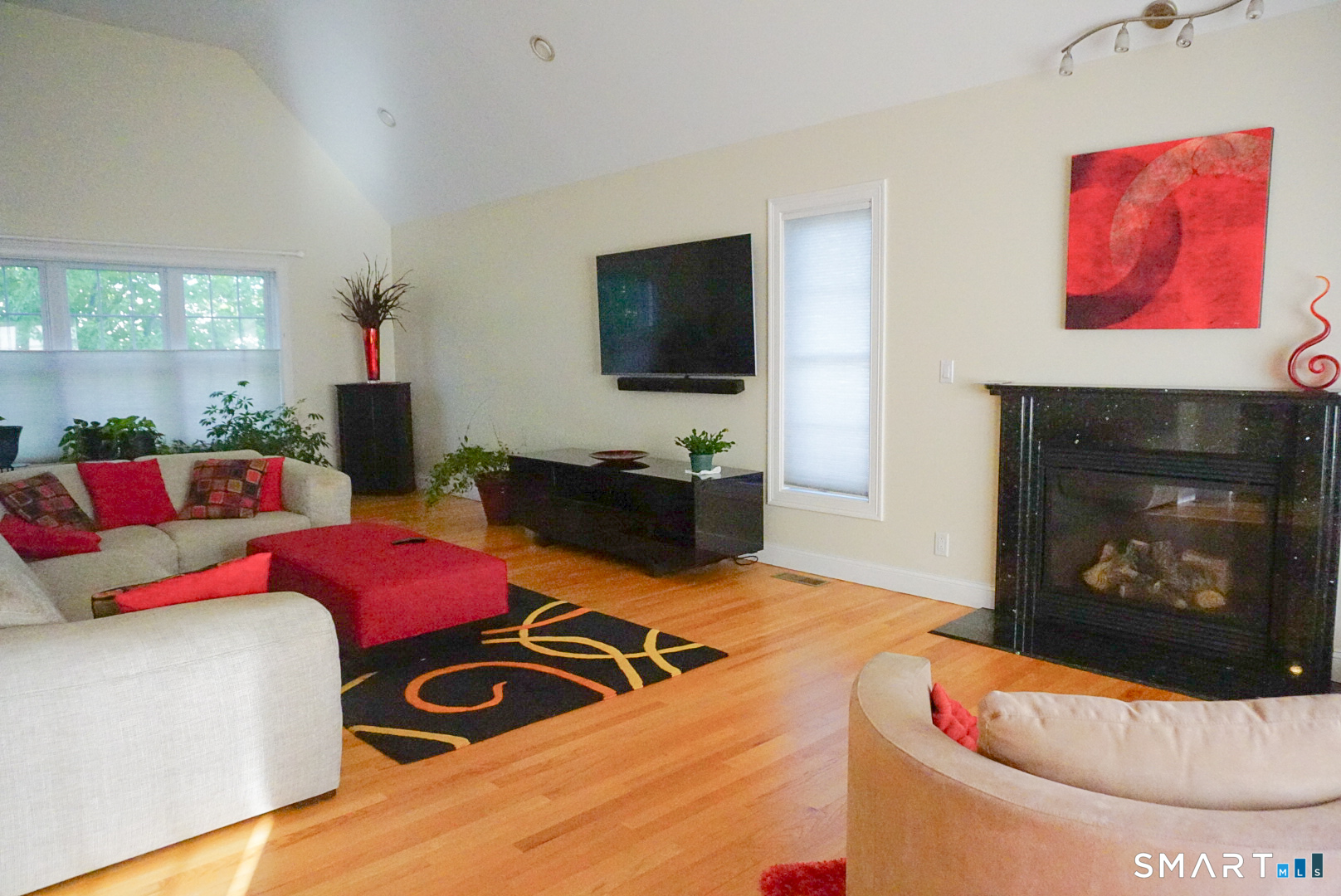 33 Knoll Ridge Court Middletown, CT 06457 - Photo 8 of 40 a living room with furniture a flat screen tv and a fireplace