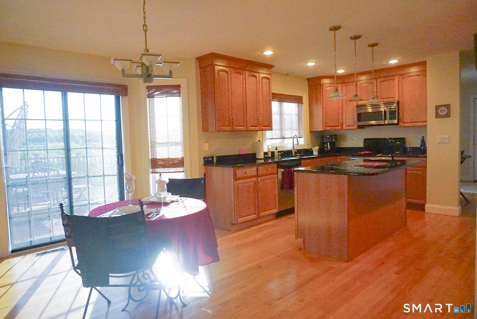 33 Knoll Ridge Court Middletown, CT 06457 - Photo 10 of 40 a kitchen with stainless steel appliances granite countertop a stove top oven a sink dishwasher a dining table and chairs with wooden floor