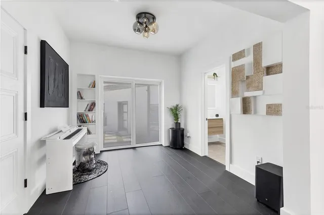 a view of a livingroom with wooden floor and furniture