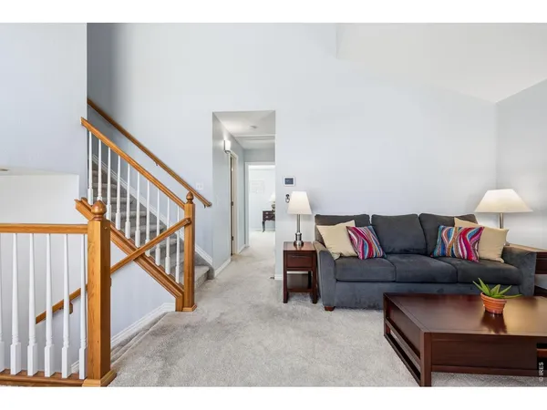 a living room with furniture and stairs