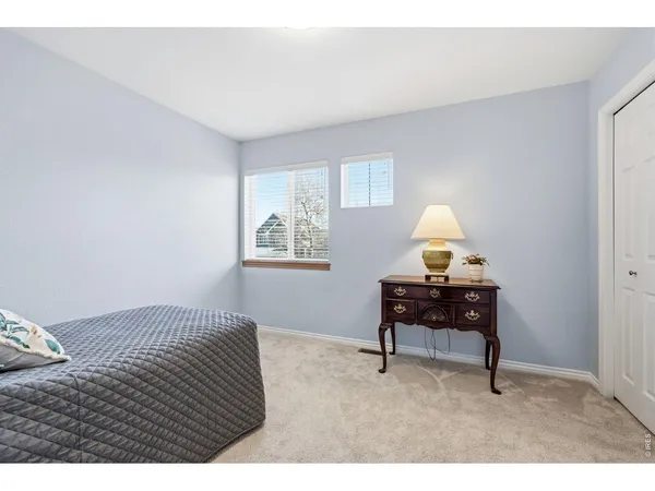 a bedroom with a bed and a desk