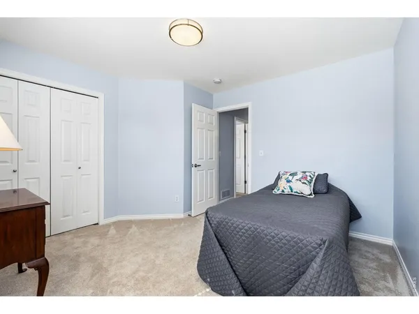a bedroom with a bed and cabinets