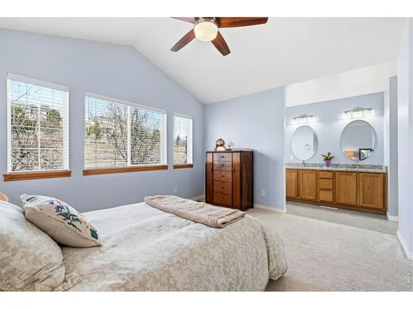 a bedroom with a bed next to a large window with the outer view