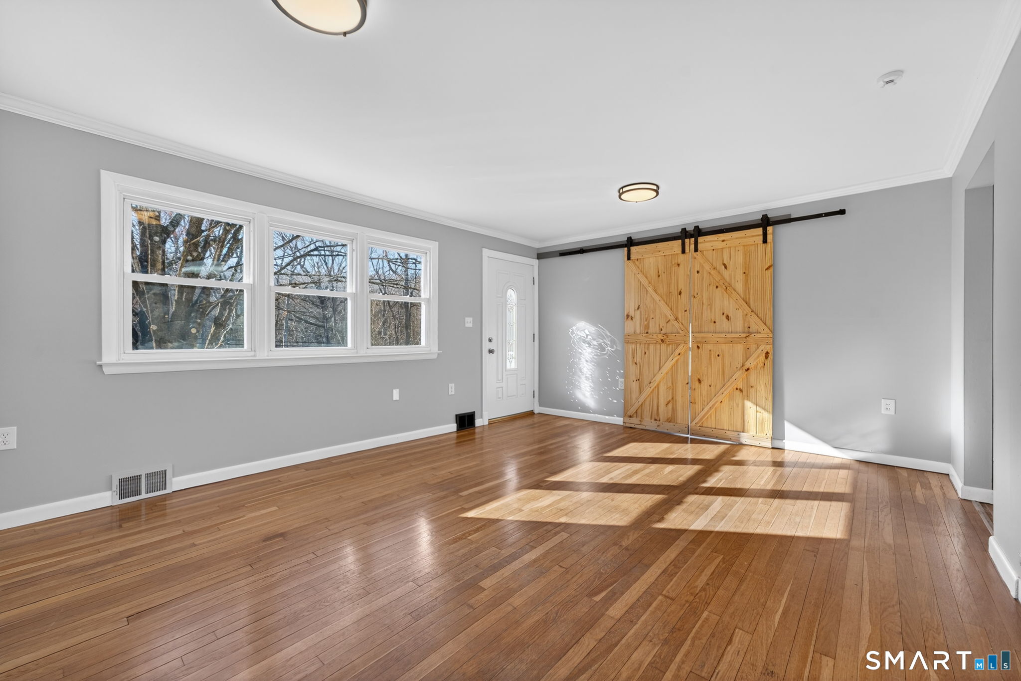 23 Holbrook Road Seymour, CT 06483 - Photo 12 of 53 a view of an empty room with wooden floor and a window