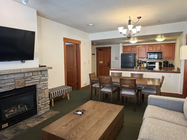 a living room with furniture a fireplace and flat screen tv