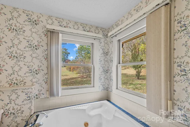 a bathroom with a bathtub and window