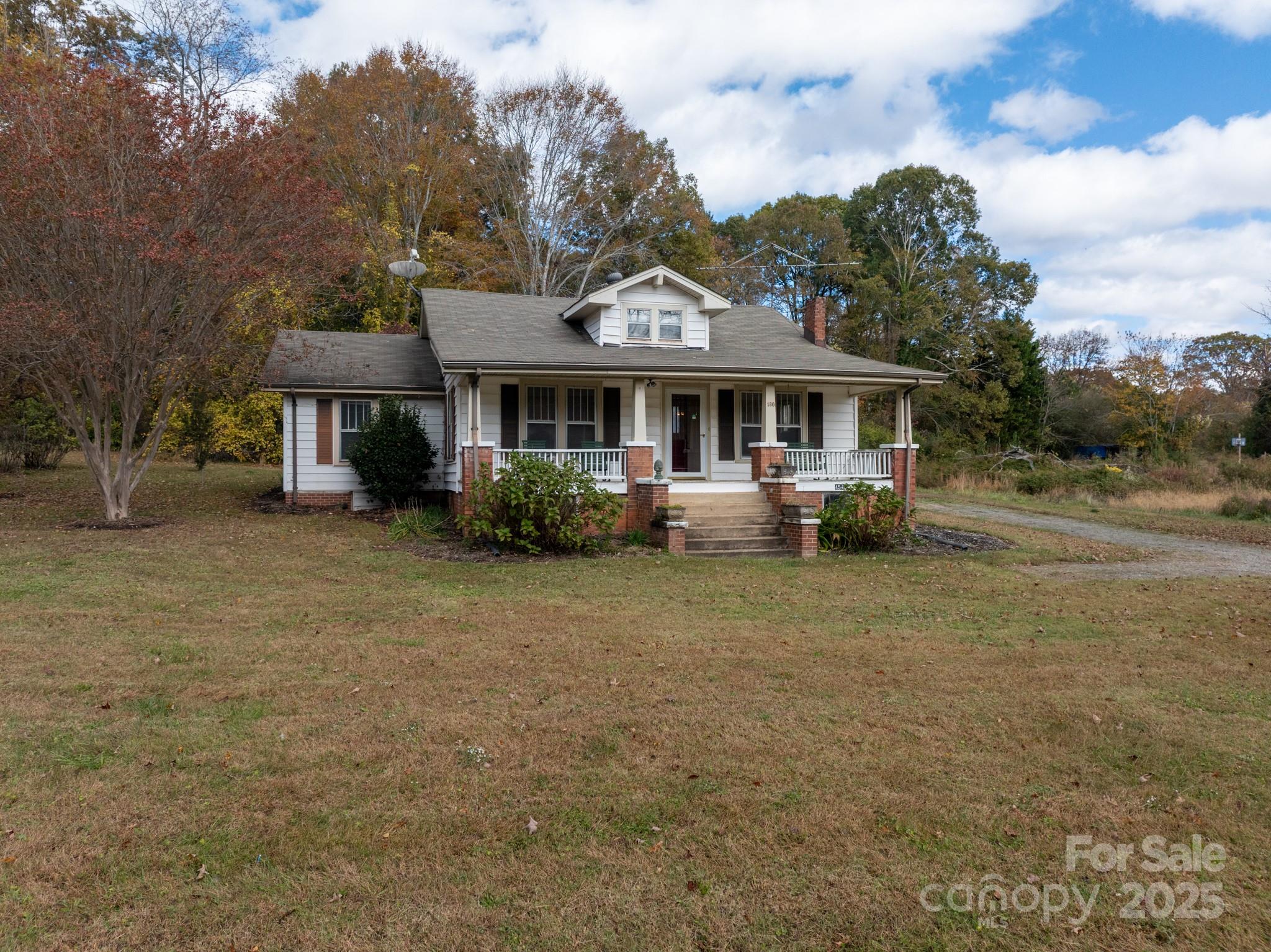 4541 Hartland Road Lenoir, NC 28645 - Photo 20 of 40 a front view of a house with a garden and trees