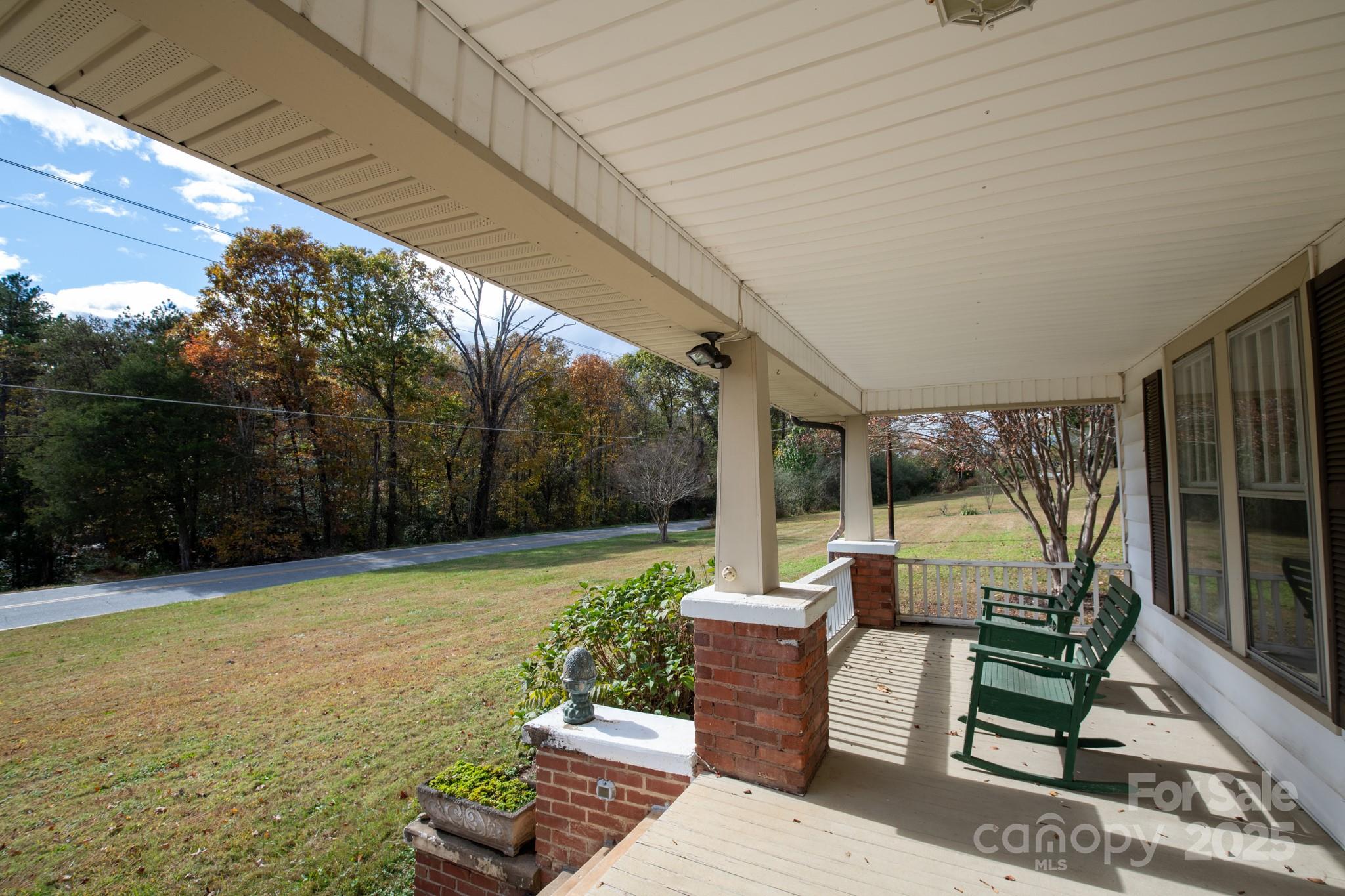 4541 Hartland Road Lenoir, NC 28645 - Photo 33 of 40 a view of a patio with couches potted plants and wooden floor