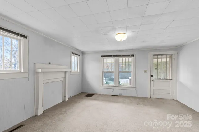 an empty room with windows and closet