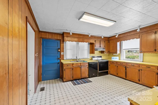 a kitchen with stainless steel appliances granite countertop a stove a sink and dishwasher