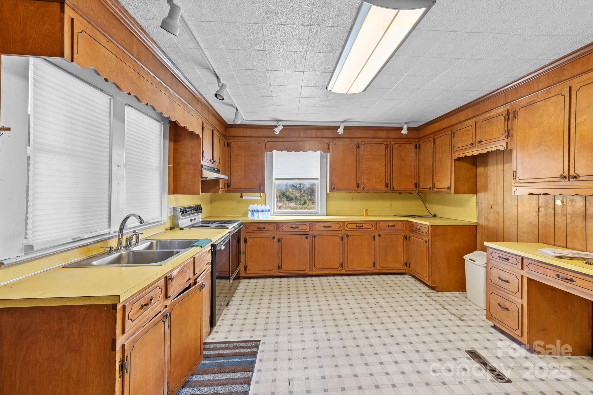 4541 Hartland Road Lenoir, NC 28645 - Photo 8 of 40 a kitchen with a sink a stove cabinets and a window
