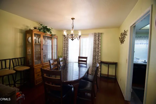 a view of a dining room with furniture and chandelier
