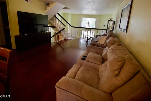 a living room with furniture and a painting on the wall