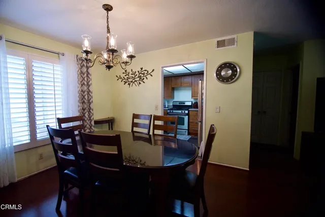 a view of a dining room with furniture and chandelier