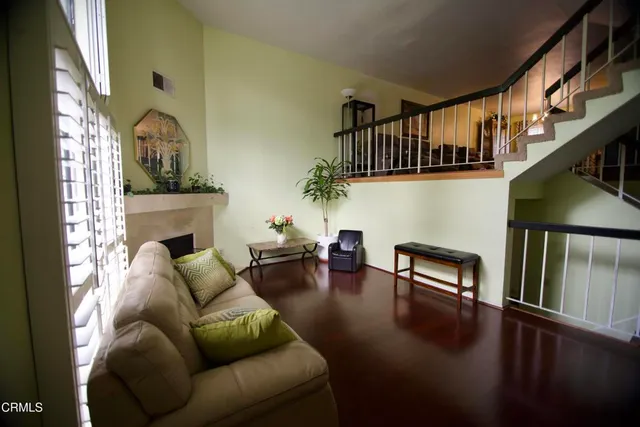 a living room with furniture wooden floor and a fireplace
