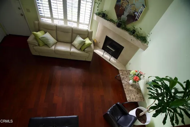 a living room with furniture and a potted plant