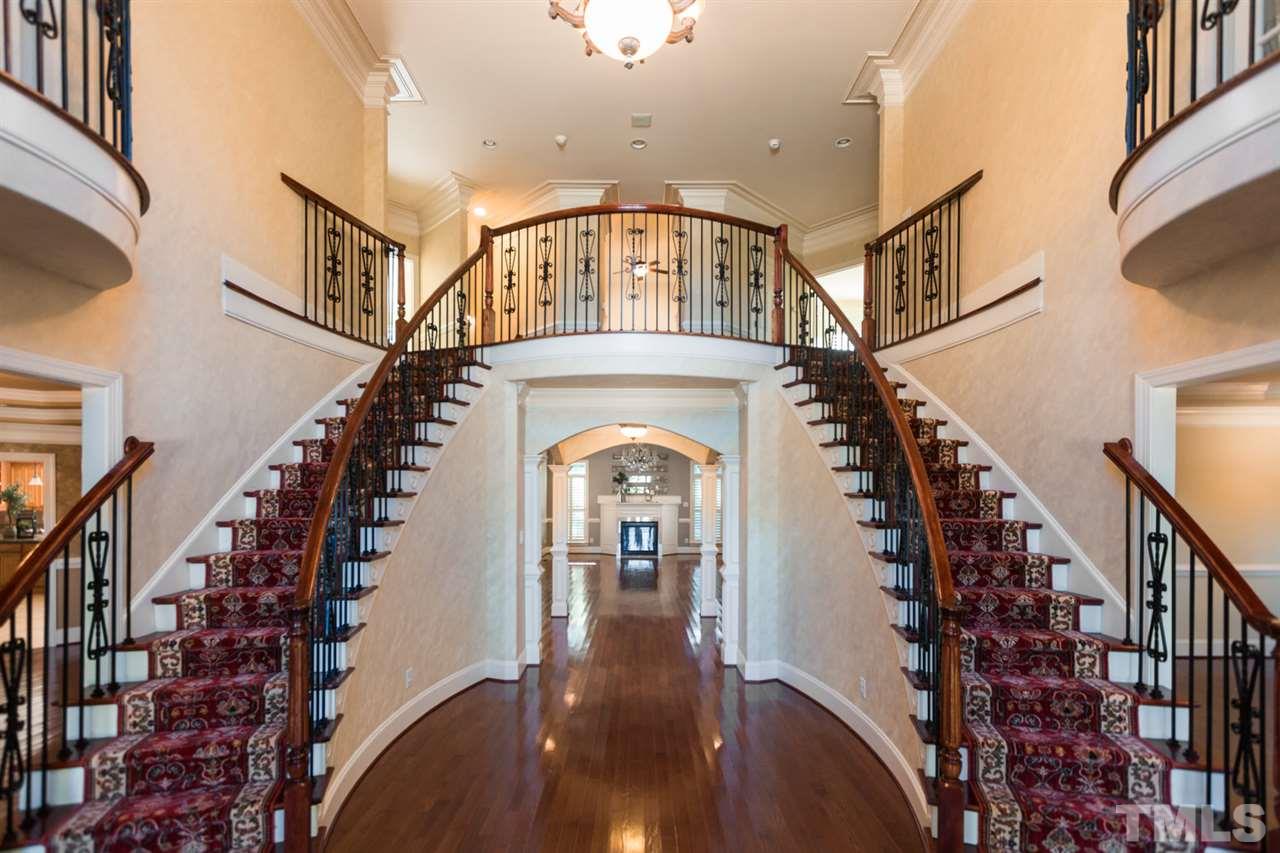 5612 Greenevers Drive Raleigh, NC 27613 - Photo 3 of 14 a view of a hallway with wooden floor windows a fireplace and entryway