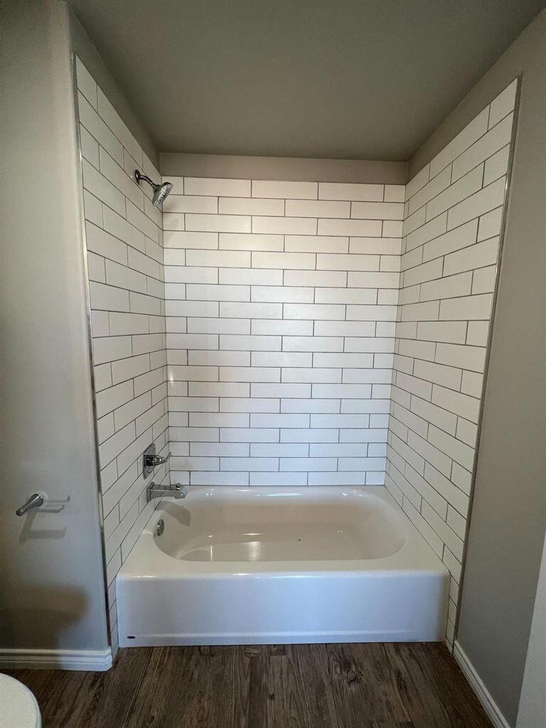 1407 17th Street, Unit A Shallowater, TX 79363 - Photo 13 of 18 a bathroom with a bathtub and shower
