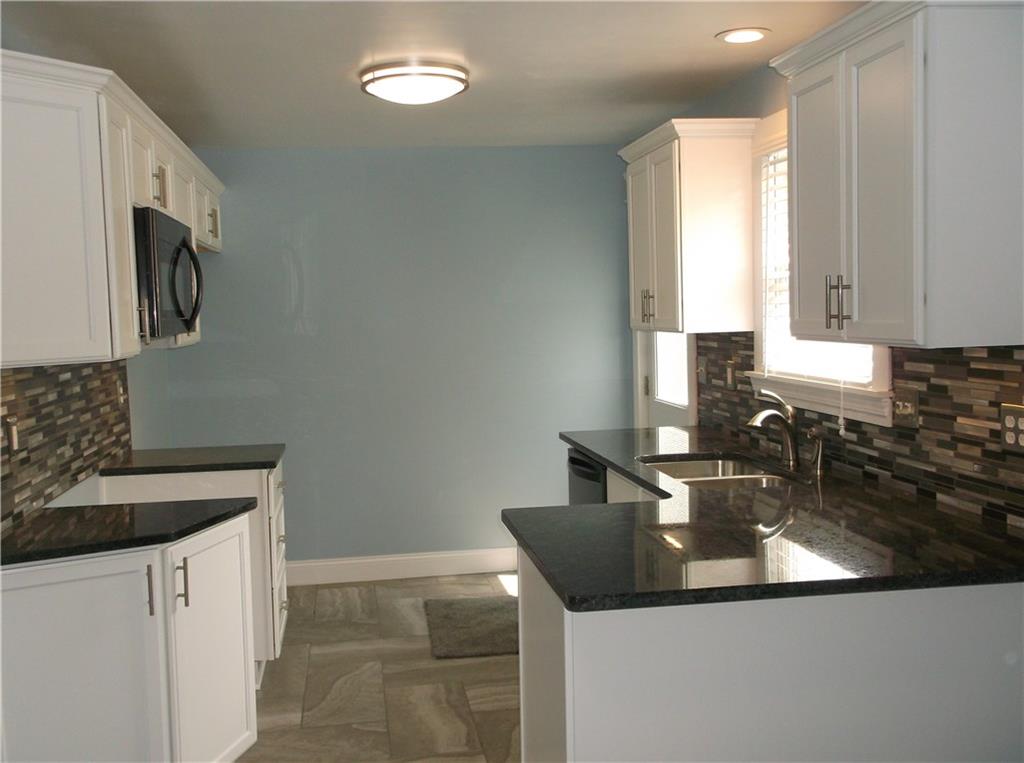 420 Rostraver Road Belle Vernon, PA 15012 - Photo 3 of 25 The eat-in kitchen is ALL NEW....from the new cupboards with soft close drawers and granite counters, to the custom back splash and ceramic tile floors!
