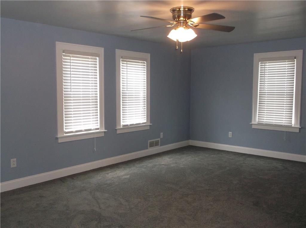 420 Rostraver Road Belle Vernon, PA 15012 - Photo 8 of 25 The large living room features lots of windows for natural lighting, a new ceiling fan and all new paint and carpeting!