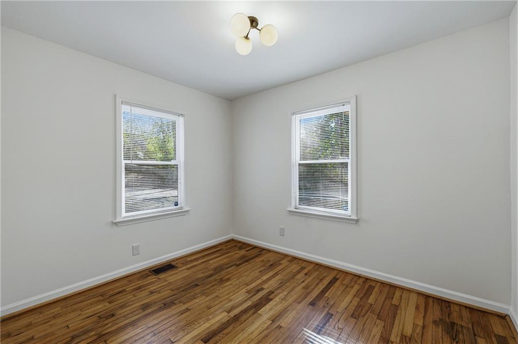 2583 Joyce Avenue Decatur, GA 30032 - Photo 11 of 30 a view of an empty room with wooden floor and a window