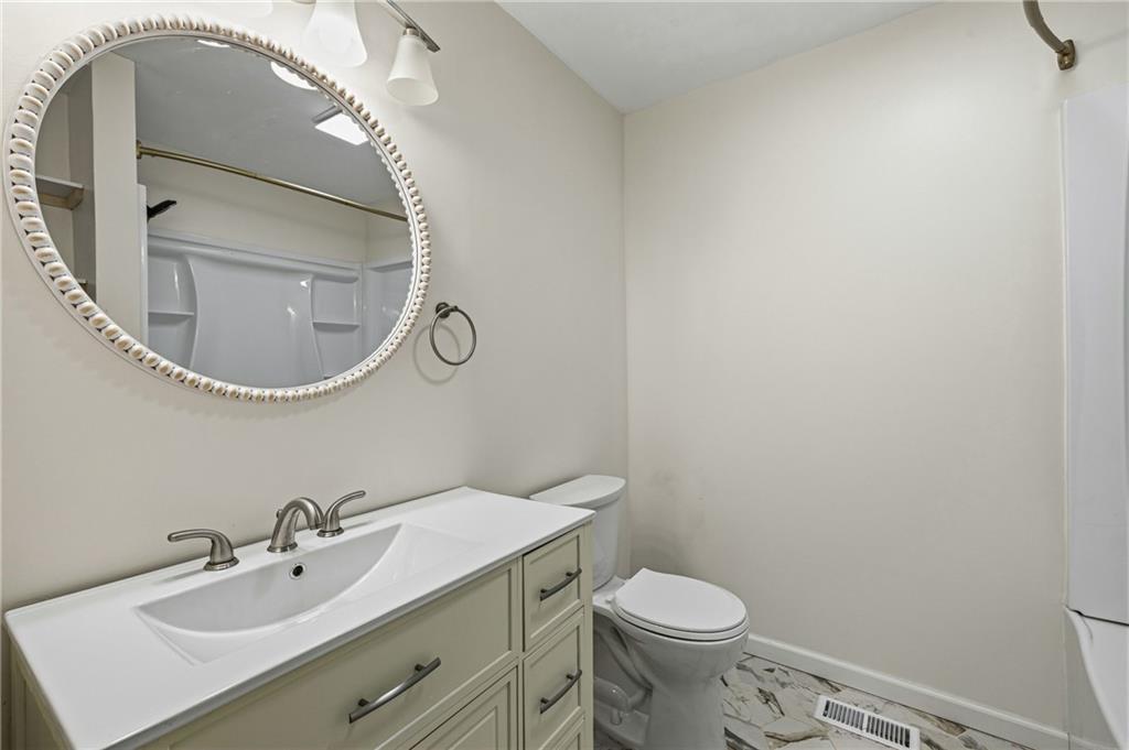 2583 Joyce Avenue Decatur, GA 30032 - Photo 13 of 30 a bathroom with a sink and a mirror