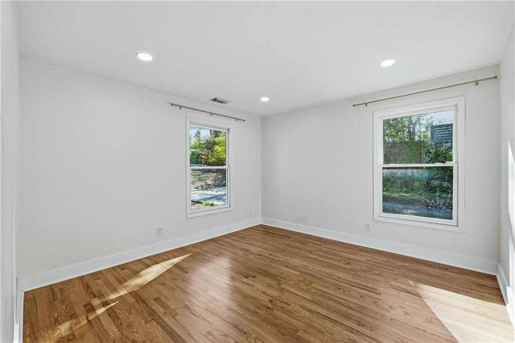 2583 Joyce Avenue Decatur, GA 30032 - Photo 15 of 30 an empty room with wooden floor and windows